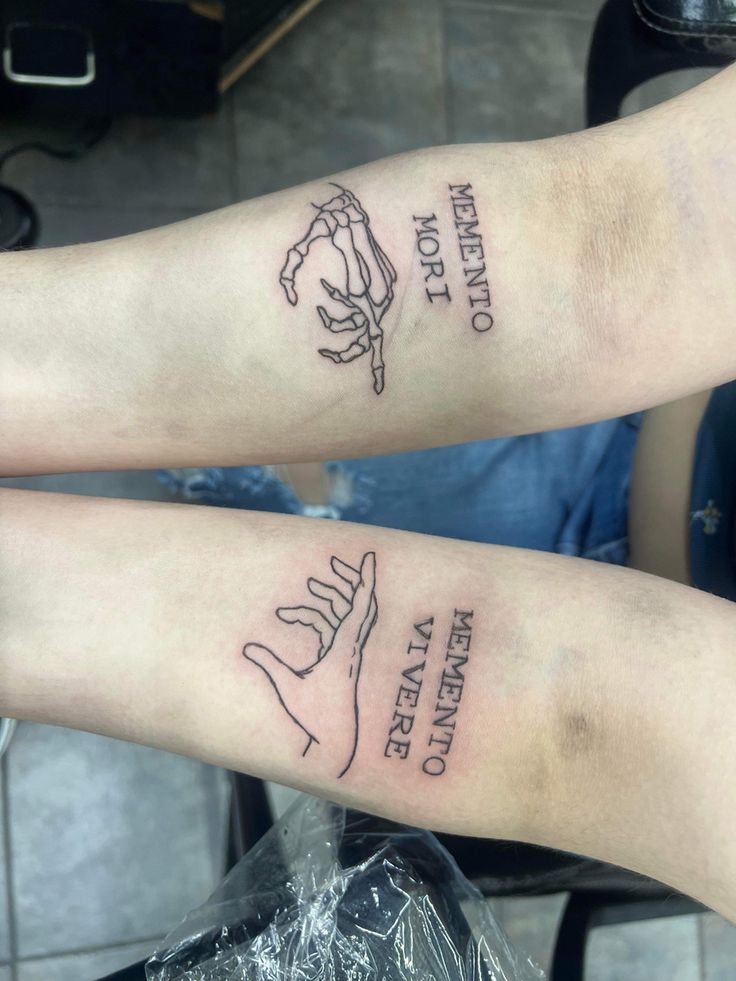 two people with matching tattoos on their arms