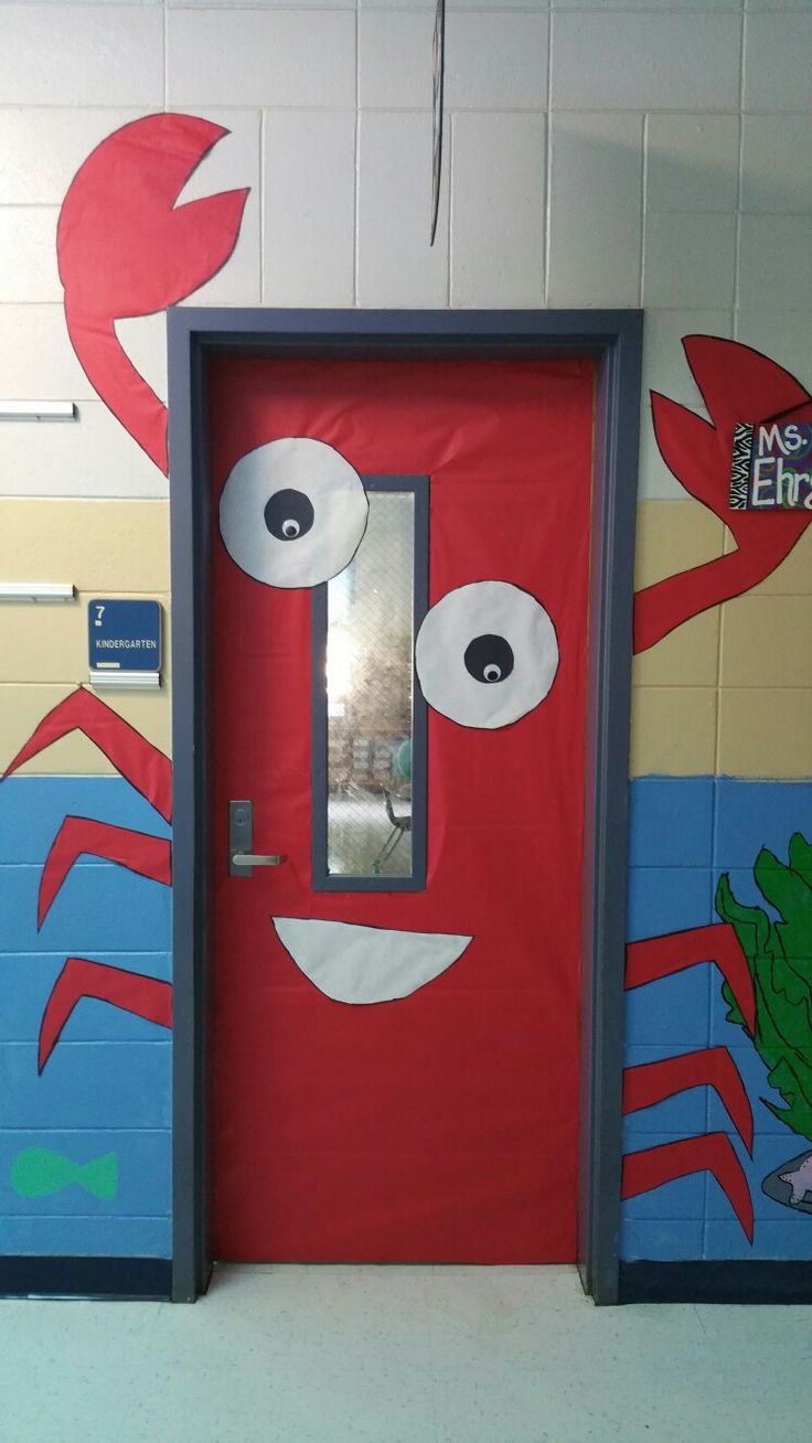 a red door with googly eyes and an octopus painted on the wall behind it