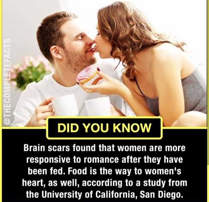 a man and woman kissing each other while holding coffee cups in front of their faces