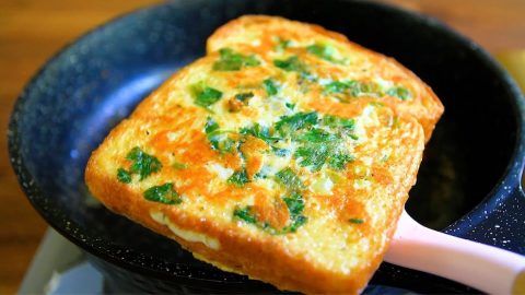 an omelet is being cooked in a skillet