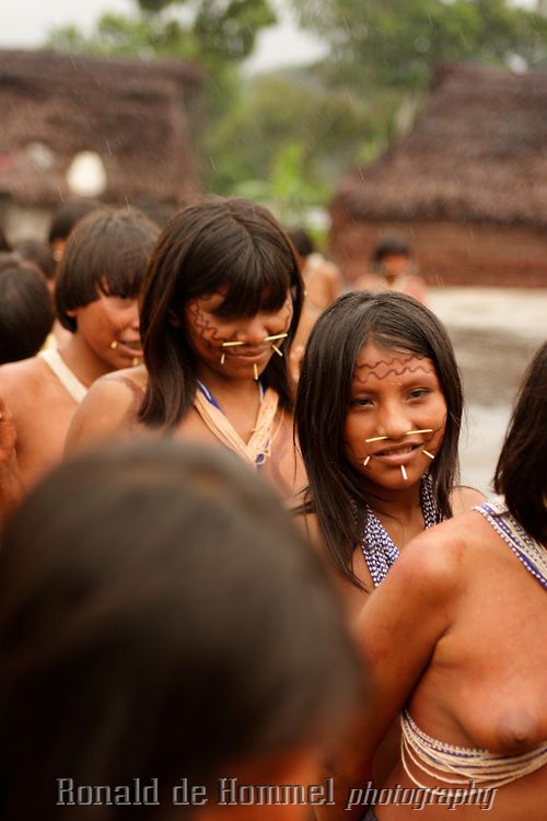 several women in native clothing standing around each other