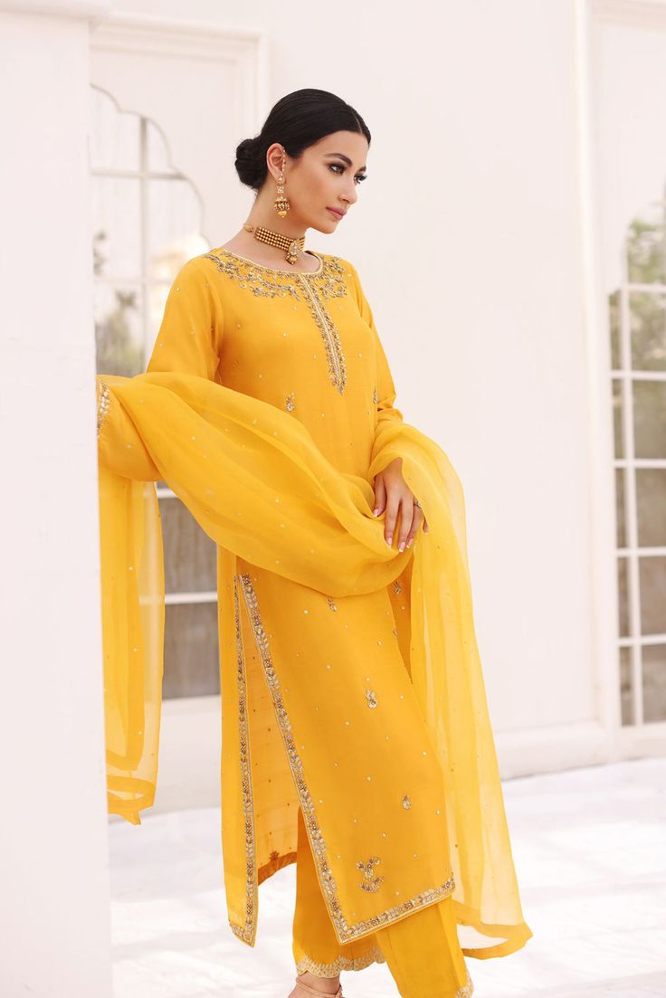 A festive mustard yellow pure raw silk long kameez with gold and antique hand craftmenship done by our expert artisans. Accompanied by a detailed zari border on straight trousers alongside pure organza dupatta with sequins spray and gotah edging, this regal design makes the perfect look for mehndis, dholkis, baraat and Tulle Embroidery, Asim Jofa, Regal Design, Borders Design, Straight Fit Pants, Luxury Wear, Pakistani Bridal Dresses, Beaded Neckline, Chiffon Dupatta