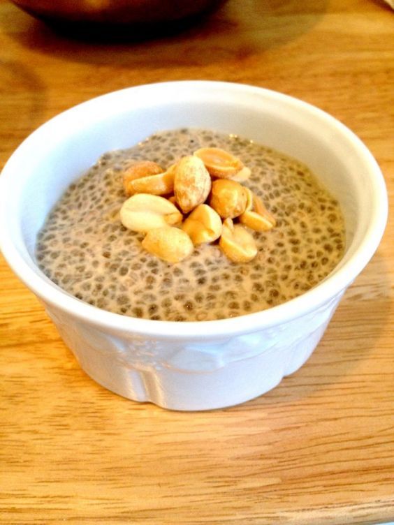 a bowl filled with oatmeal and nuts on top of a wooden table