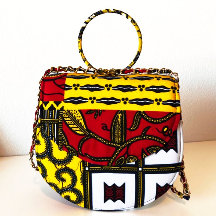 This gorgeous ZAI Handbag is perfect for travel, work, or parties. Our light bag is sourced from Ghana and made of Authentic 100% African print fabric with stitch details for a luxe look and, chain that can be carried as single or double. The Interior accessory and pockets help you keep items organized in your purse. This bag is individually handcrafted and lovingly made to be unique to you Description: African Print handbag The inner is fully lined with black fabric Interior compartments for or Yellow Fabric Everyday Bag, Yellow Fabric Rectangular Bag, Yellow Rectangular Fabric Bag, Trendy Fabric Shoulder Bag For Travel, Fabric Shoulder Bag For Gifts, Chic Fabric Shoulder Bag For Travel, Fabric Shoulder Bag For Gift, Fabric Shoulder Bag Suitable For Gifts, Yellow Bag With Chain Strap For Everyday Use