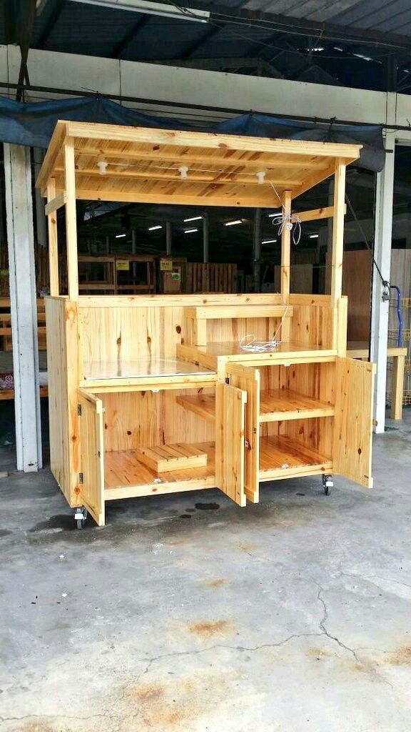 an outdoor bar made out of pallets in a garage with no one around it