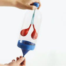 a person is pouring liquid into a bottle with a toothbrush in it while another hand holds the container