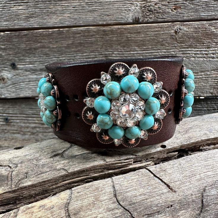 "Brown leather bracelet that has a pattern of dots. It is adorned with copper Turquoise Howlite/Clear crystal conchos. Measures 7.75\" to 8.25\" with two snaps to create two sizes. Lifetime guarantee on all crystals." Turquoise Leather Concho Bracelets, Western Style Turquoise Bracelet With Concho, Western Turquoise Bracelets With Concho, Western Turquoise Bracelet With Concho, Adjustable Turquoise Western Bracelet, Adjustable Turquoise Cuff Bracelet With Concho, Adjustable Turquoise Leather Bracelet With Concho, Turquoise Dog Collar, Jewelry Making Business