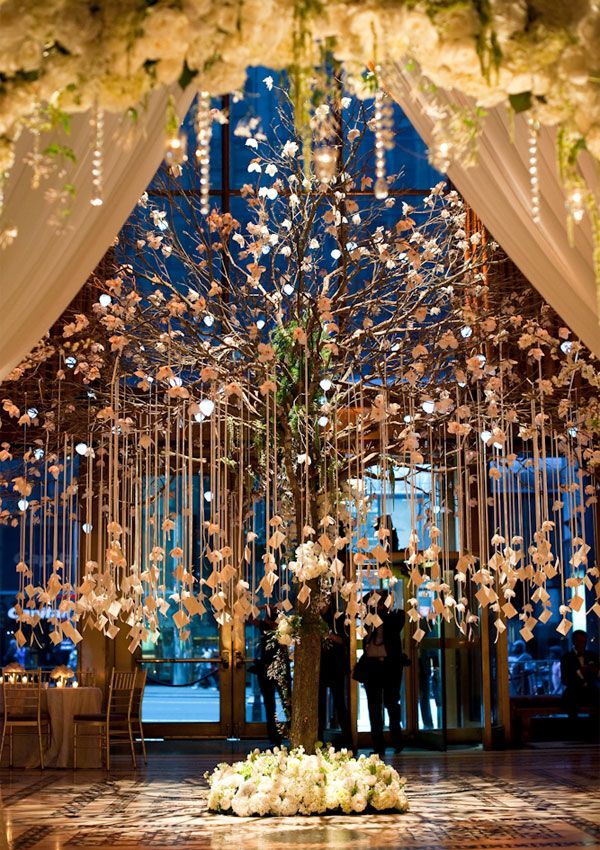 an image of a wedding venue with flowers and chandelier hanging from the ceiling