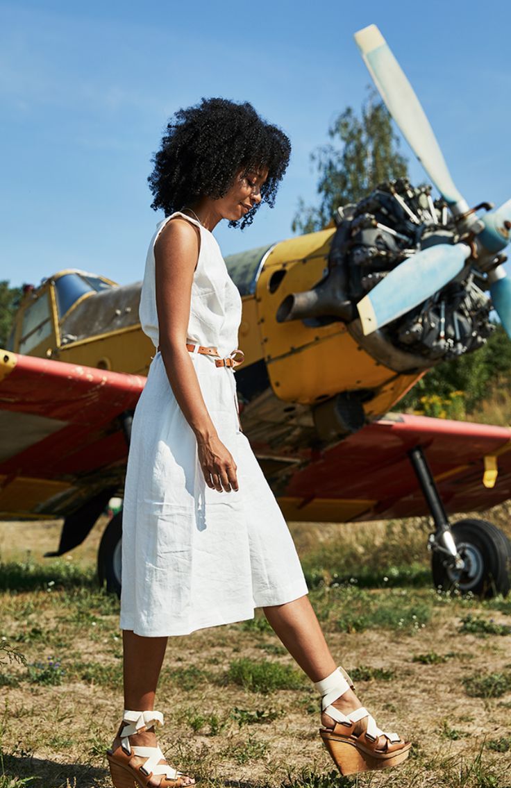 a woman standing in front of an airplane