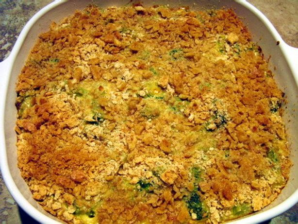 a casserole dish with broccoli and cheese in it on a table