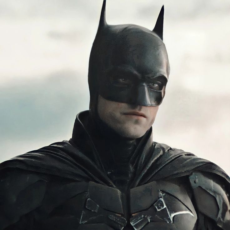 the dark knight in batman's costume is looking at something with his eyes closed