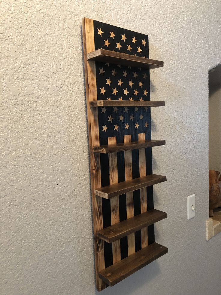 an american flag made out of wooden pallets on the wall next to a mirror