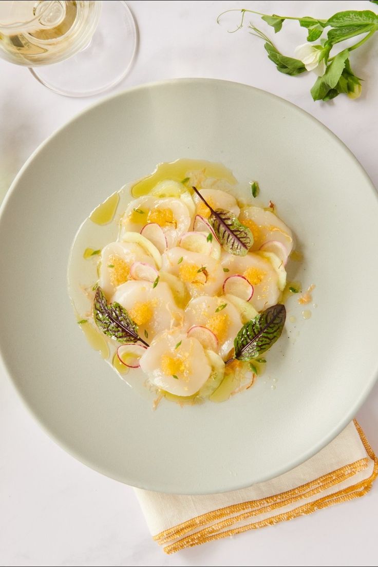 a white plate topped with pasta and shrimp