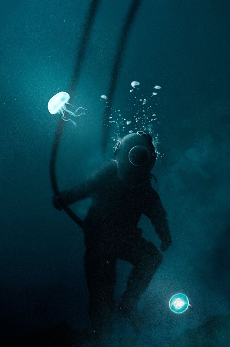 a scuba diver in the water with jellyfish