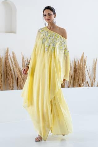 Yellow cape with sequin and beads embroidery in floral motifs. Paired with printed pleated skirt. - Aza Fashions Summer Hand Embellished Designer Sets, Hand Embellished Georgette Dresses For Summer, Bohemian Hand Embellished Georgette Dresses, Spring Embellished Dresses With Traditional Drape, Spring Georgette Dress With Mirror Work, Yellow Embellished Dress For Navratri, Traditional Drape Summer Dress For Reception, Embellished Yellow Dress For Navratri, Traditional Drape Summer Reception Dress