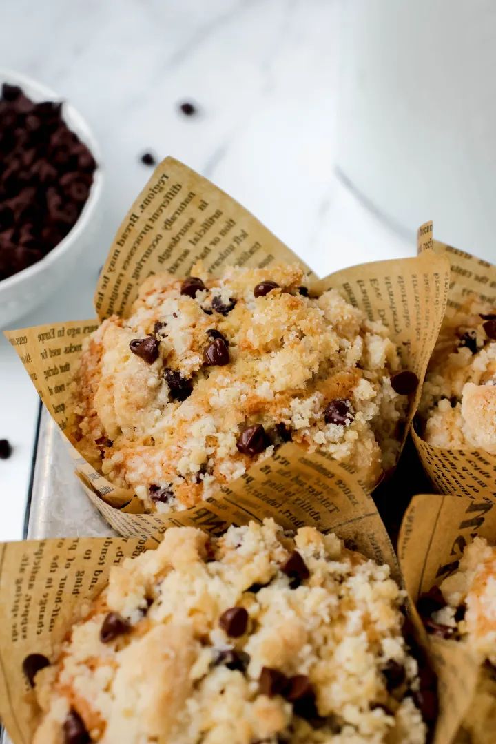 three muffins sitting on top of each other next to a cup of coffee