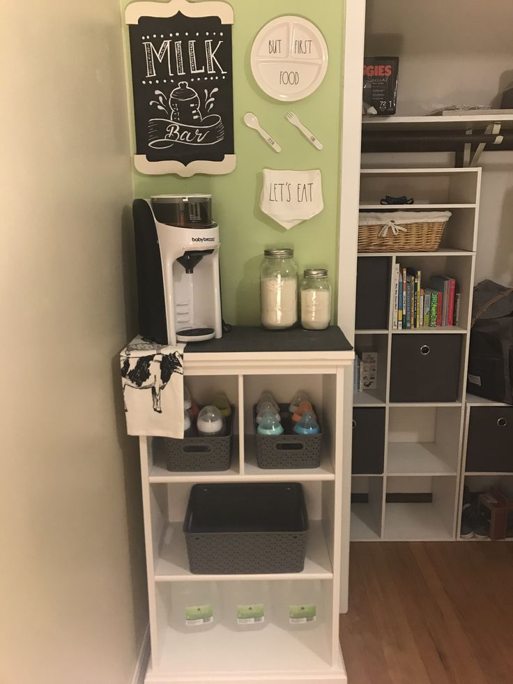 there is a coffee maker on top of the bookcase in this small kitchen area