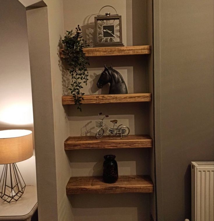 a room with some shelves and a horse head on the wall next to a lamp