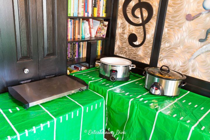 there is a green table cloth with musical notes on it and two potted pans