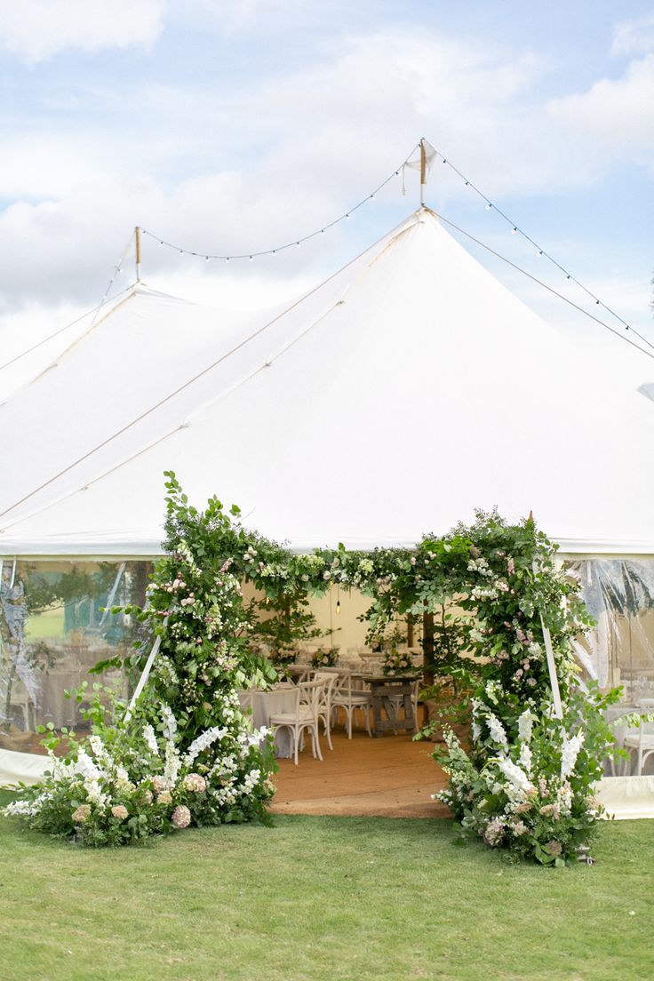 a white tent set up with tables and chairs