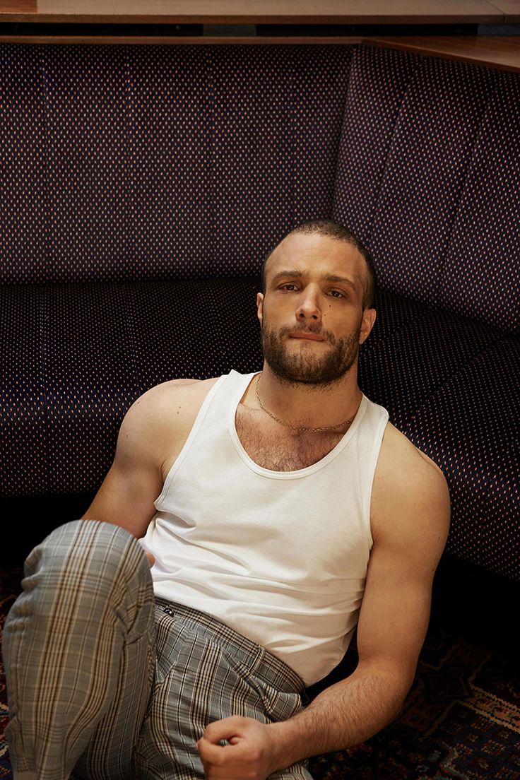 a man sitting on the floor in front of a couch