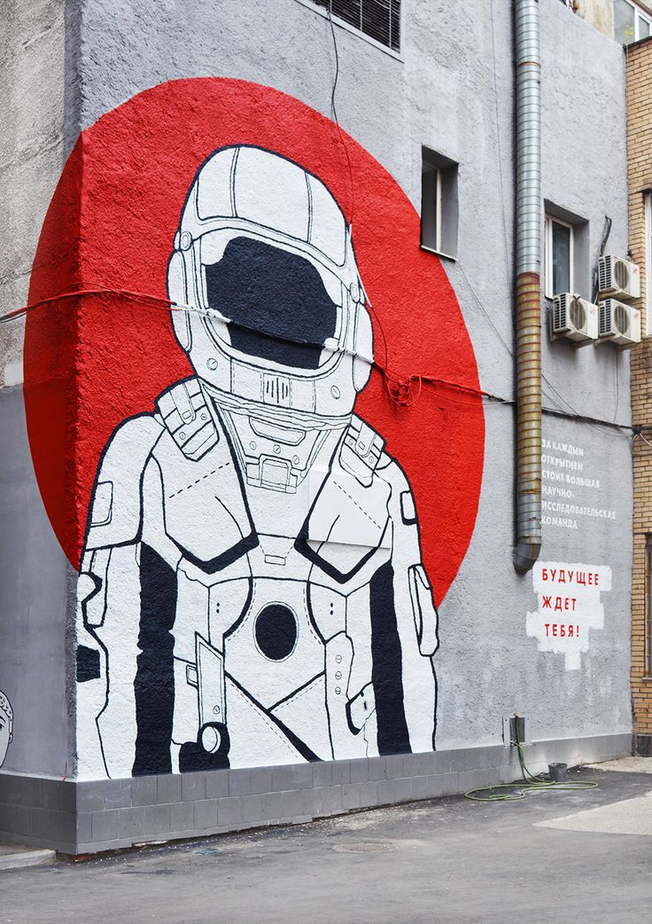 a mural on the side of a building with a man in an astronaut's suit