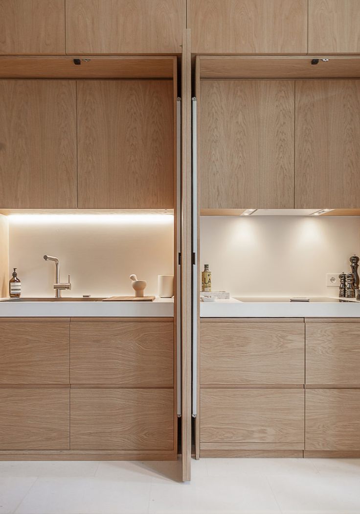 an open kitchen with wooden cabinets and white counter tops