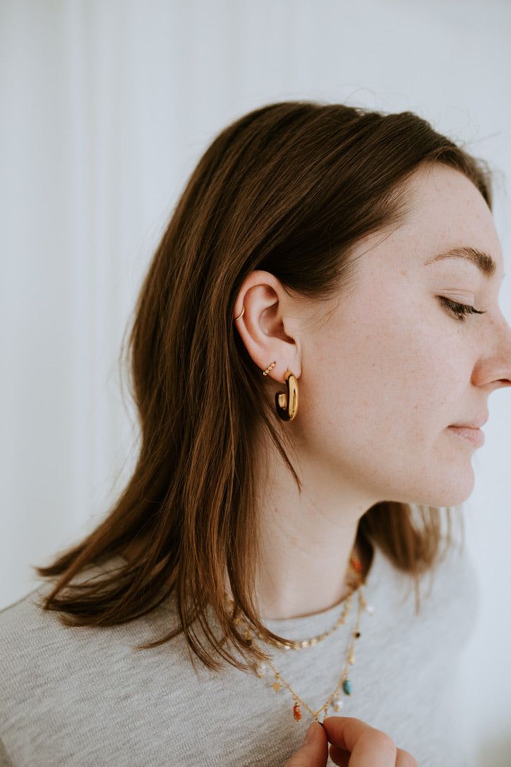 Add a touch of understated elegance with The Mini Dottie Hoops. These delicate hoops are the perfect way to elevate your everyday look with a subtle glimmer. With their tiny, minimalistic design, these hoops provide just the right amount of shine to make a statement while maintaining a light, barely-there charm. The Details - Material: 18K Gold Filled—offering a luxurious gold finish with long-lasting durability and a shine that won’t fade. - Hoop Size: 10mm—small and delicate, providing a refin Tiny Gold Huggie Earrings Simple Style, Simple Tiny Gold Huggie Earrings, Everyday 14k Gold Filled Huggie Earrings, Tiny Gold Minimalist Huggie Earrings, Simple Gold Huggie Earrings Tarnish Resistant, Gold Dainty Huggie Earrings For Everyday, Dainty Gold Huggie Earrings For Everyday, Delicate Yellow Gold Huggie Earrings For Everyday, Everyday Dainty Gold Huggie Earrings