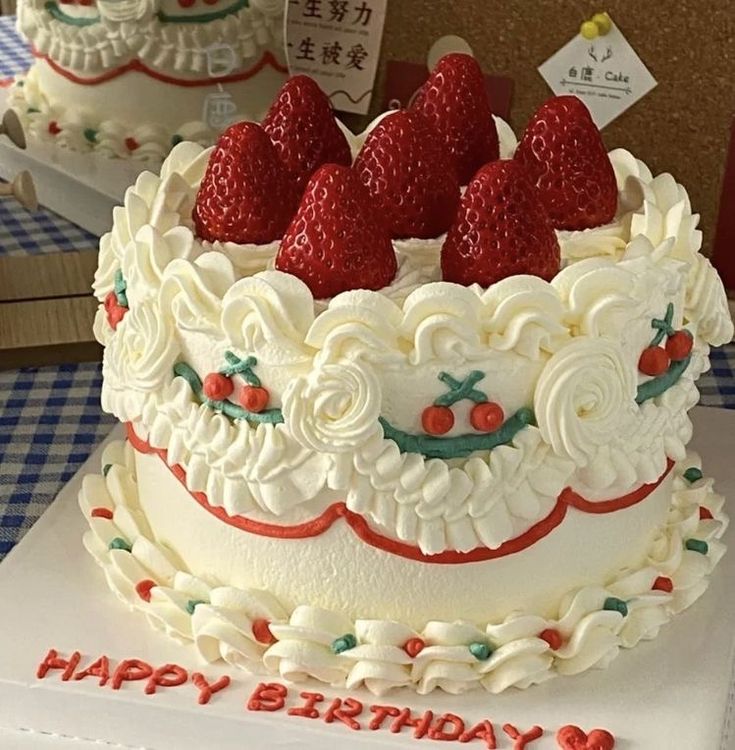 there is a cake with strawberries on it and the words happy birthday written in chinese