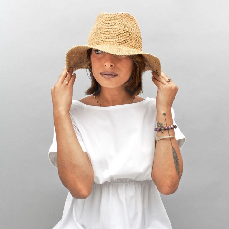 Introducing the Belfry Llina, the ultimate hat for those looking to channel a western, casual style. Made with raffia straw, this packable hat features an adjustable and tieable chinstrap, allowing for versatile wear. FEATURESStyle: Outdoor with Snap-Up BrimMaterial: 100% Raffia Dimensions: 4" Crown, 3" BrimNotes: Brim can be attached to the crown of the hat via snap fasteners on each side.