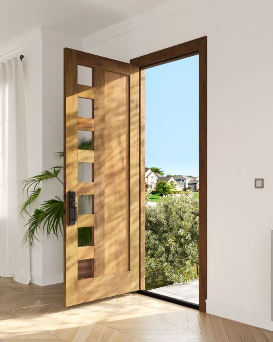 an open door in a white room with wooden flooring and potted plant next to it