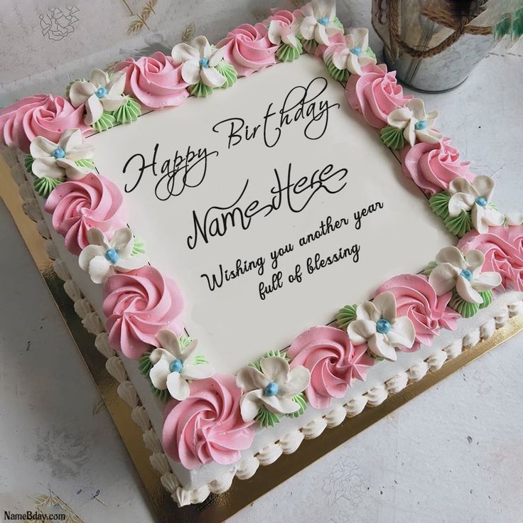 a birthday cake with pink and white frosting flowers on the bottom is sitting on a table