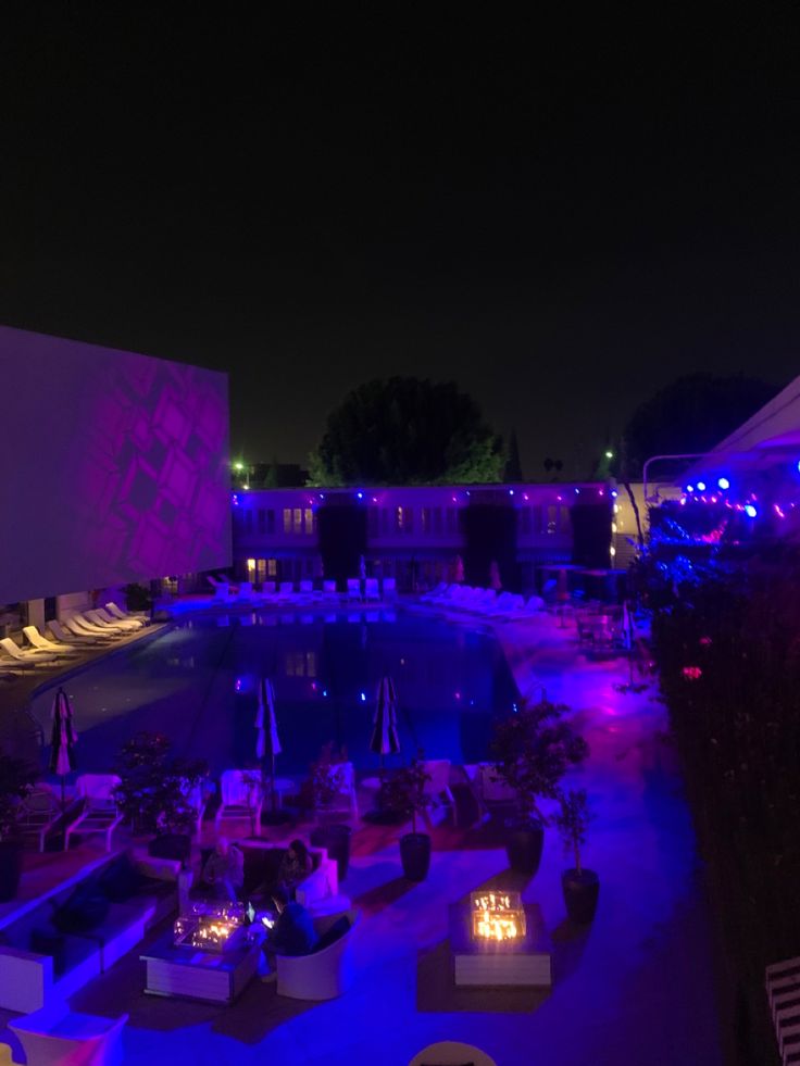 an outdoor pool at night with lit candles