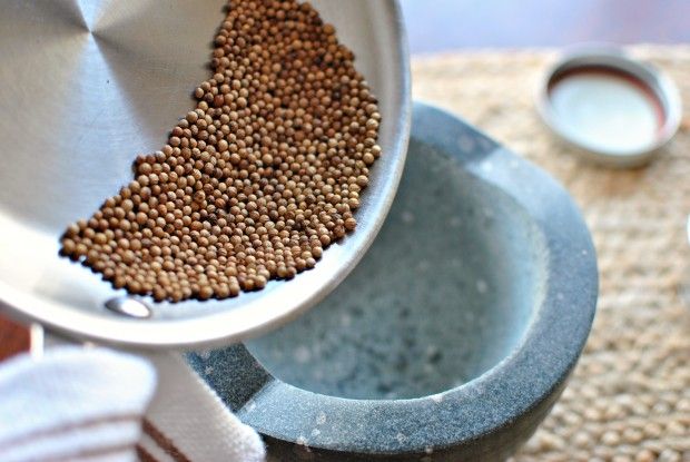 a metal bowl filled with brown food on top of a table