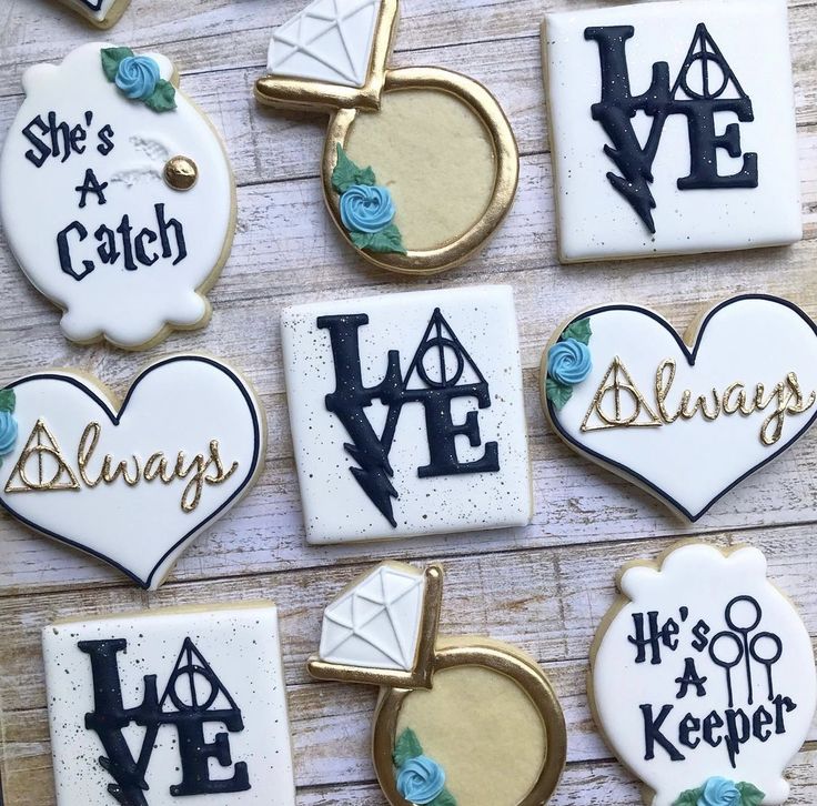 decorated cookies are arranged on a wooden table