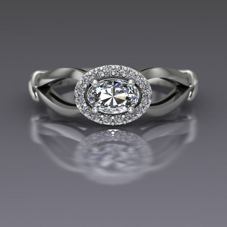 "An oval cut diamond is sideways set and surrounded by a halo of diamonds in this 14k white gold ring. Diamond is the April birthstone and has been given as an engagement ring for centuries. This petite east-west set ring measures about 7mm at the widest point. Oval Diamond Dimensions6x4mm (approx.) Carat Weight .37(approx.) EnhancementNatural ColorF-G ClaritySI1 CutVery Good PolishVery Good Diamonds Number16 EnhancementNatural Carat Total Weight0.12 ColorG-H ClaritySI2-I1 CutVery Good PolishVer Oval Diamond White Halo Ring With Rose Cut Diamonds, Diamond White Oval Halo Ring With Brilliant Cut, Oval Brilliant Cut Diamond White Halo Ring, Oval Halo Ring In Diamond White, Oval Diamond White Halo Ring, Oval Diamond White Ring With Halo, Oval Halo Ring With Diamond Accents In Platinum, Oval Halo Ring In Platinum With Diamond Accents, Oval Platinum Halo Ring With Diamond Accents