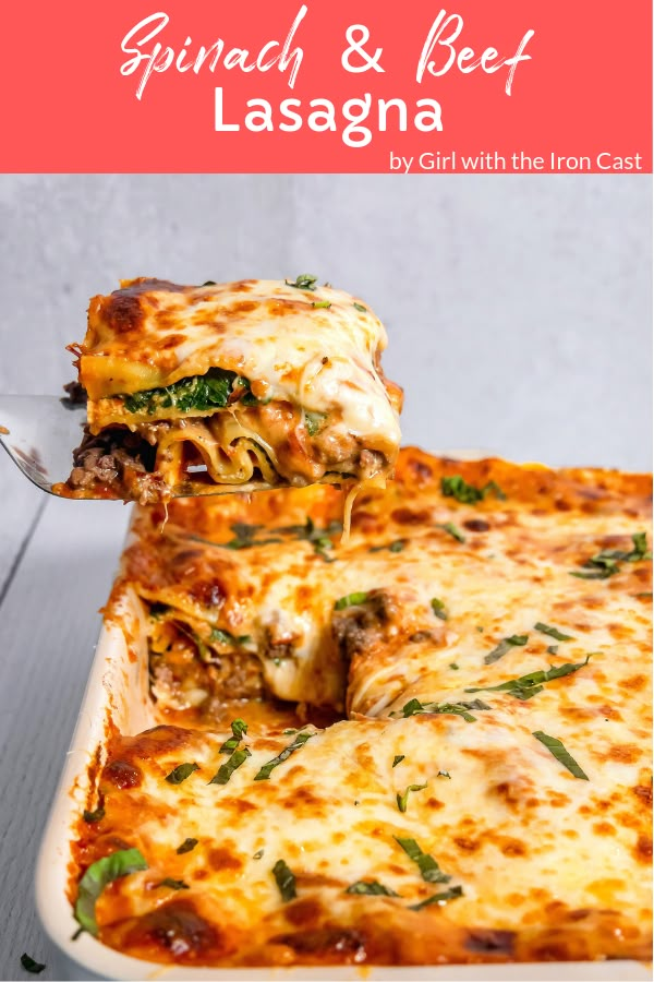 spinach and beef lasagna in a casserole dish with a serving spoon