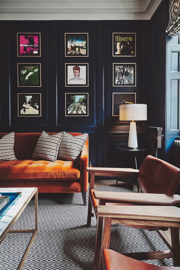 a living room filled with furniture and pictures on the wall