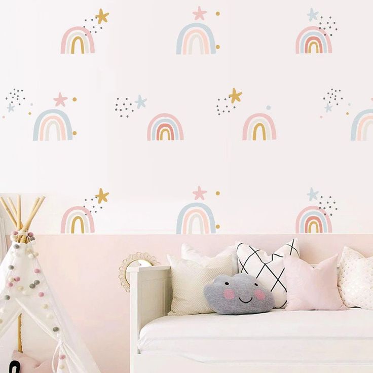 a child's bedroom with pink walls and rainbow wallpaper