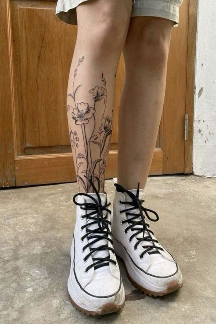 the legs and ankles of a person with tattoos on them