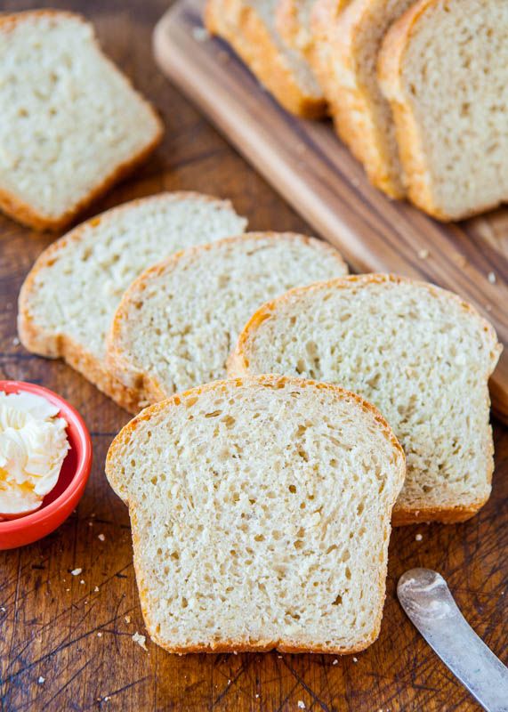 slices of white bread on a cutting board with butter