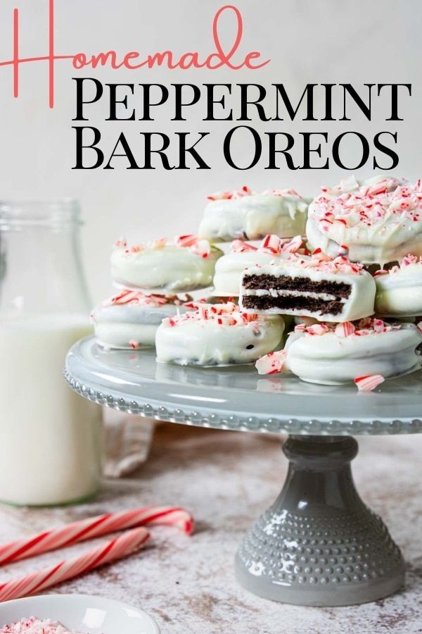 homemade peppermint bark oreos on a cake plate with milk and candy canes