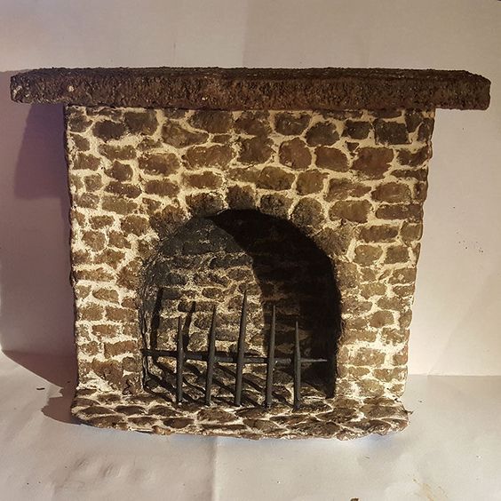 an old brick fireplace with iron bars on the front and sides, against a white background