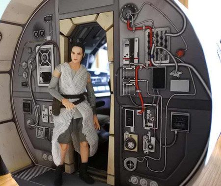 a star wars action figure is posed in front of a door