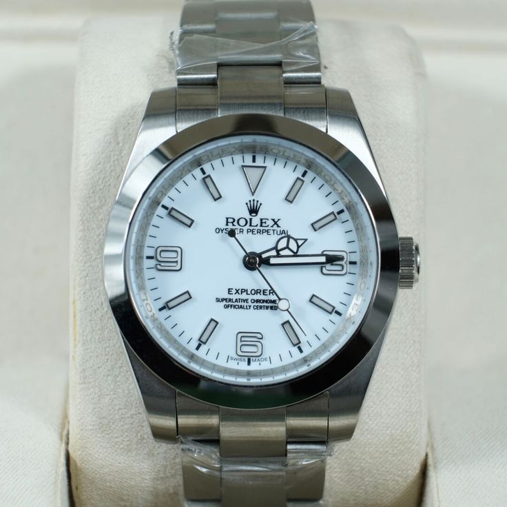 This Rolex Explorer stands out with its pristine white dial, a unique twist on a classic adventure watch. The luminous hands and markers and the signature 3-6-9 numerals ensure effortless legibility in any environment. Crafted from robust 904L Oystersteel, the case and bracelet guarantee resilience against the elements, a hallmark of the Explorer line. Powered by a precision automatic movement, this timepiece delivers exceptional accuracy and reliability, even under demanding conditions. The 36m Classic White Automatic Watch, Classic White Watch With Metal Dial, Classic White Watches With Metal Dial, Classic White Watch Accessories With Metal Dial, White Timeless Watch With Metal Dial, Timeless White Watch Accessories With Round Dial, Timeless White Round Dial Watch Accessories, Timeless White Quartz Watches, Timeless White Chronometer Watch Accessories