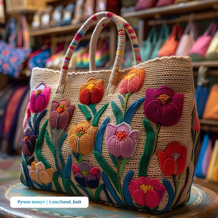 a handbag with flowers on it sitting on a table in front of a store