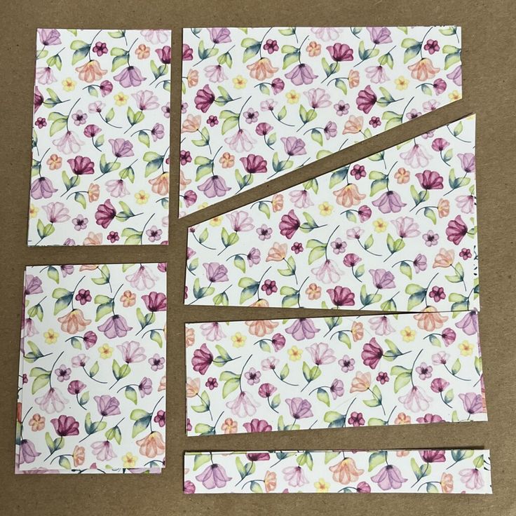 four pieces of paper with flowers on them are cut into squares and placed on top of each other