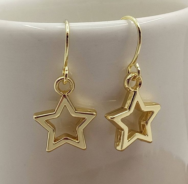 Three Pairs  Minimalist Gold Star Earrings Small Star Earrings Gold Dangle Open Star Earrings Small Gold Star Charms dangle from minimalist gold filled ear wire. Very simple, yet impactful, in design.  These Open Star Earrings are certain to become your favorite accessory. Each pair of Star Earrings will arrive in an organza pouch with a matching polishing cloth. Gift packaging and gift card cheerfully provided upon request! Hanging Star Earrings, Minimalist Gold Jewelry Earrings, Gold Star Earrings Aesthetic, Star Gold Jewelry, Gold Star Jewelry Aesthetic, Gold Star Accessories, Simple Gold Dangle Earrings, Star Earrings Gold, Dangly Gold Earrings