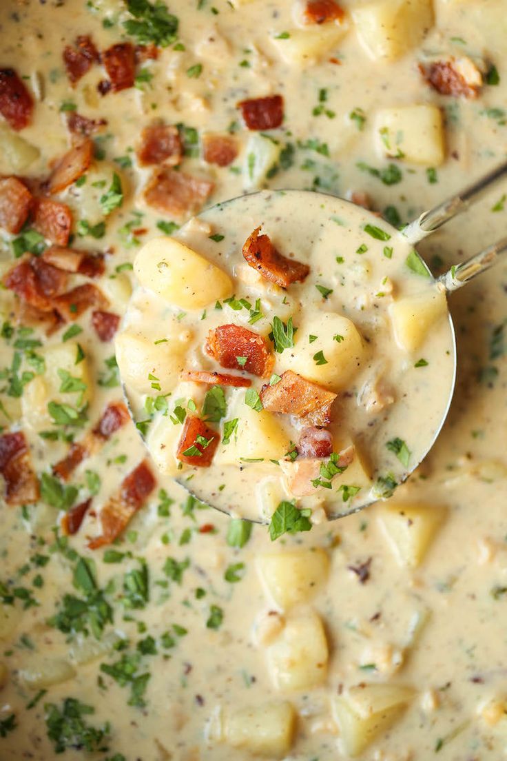 a spoon full of soup with potatoes and bacon