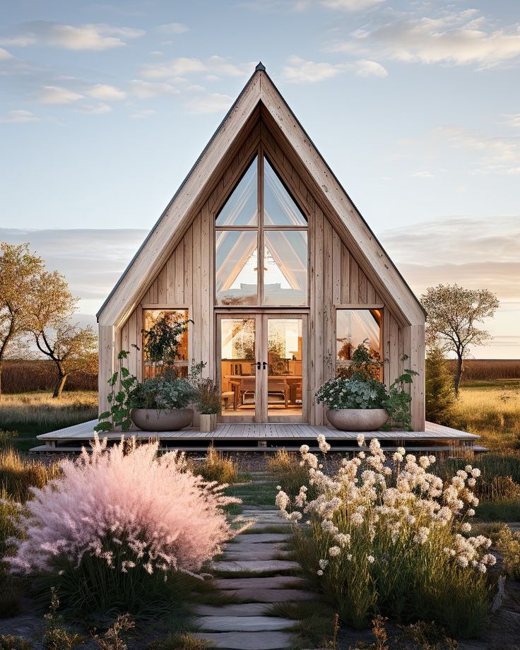 a small wooden house sitting on top of a lush green field